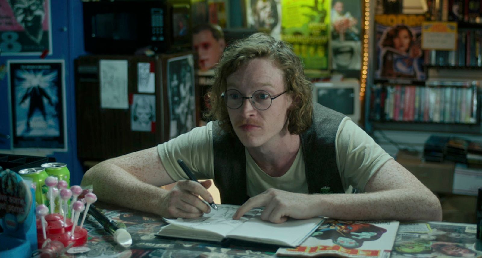 a person sitting at a table with a book and pen