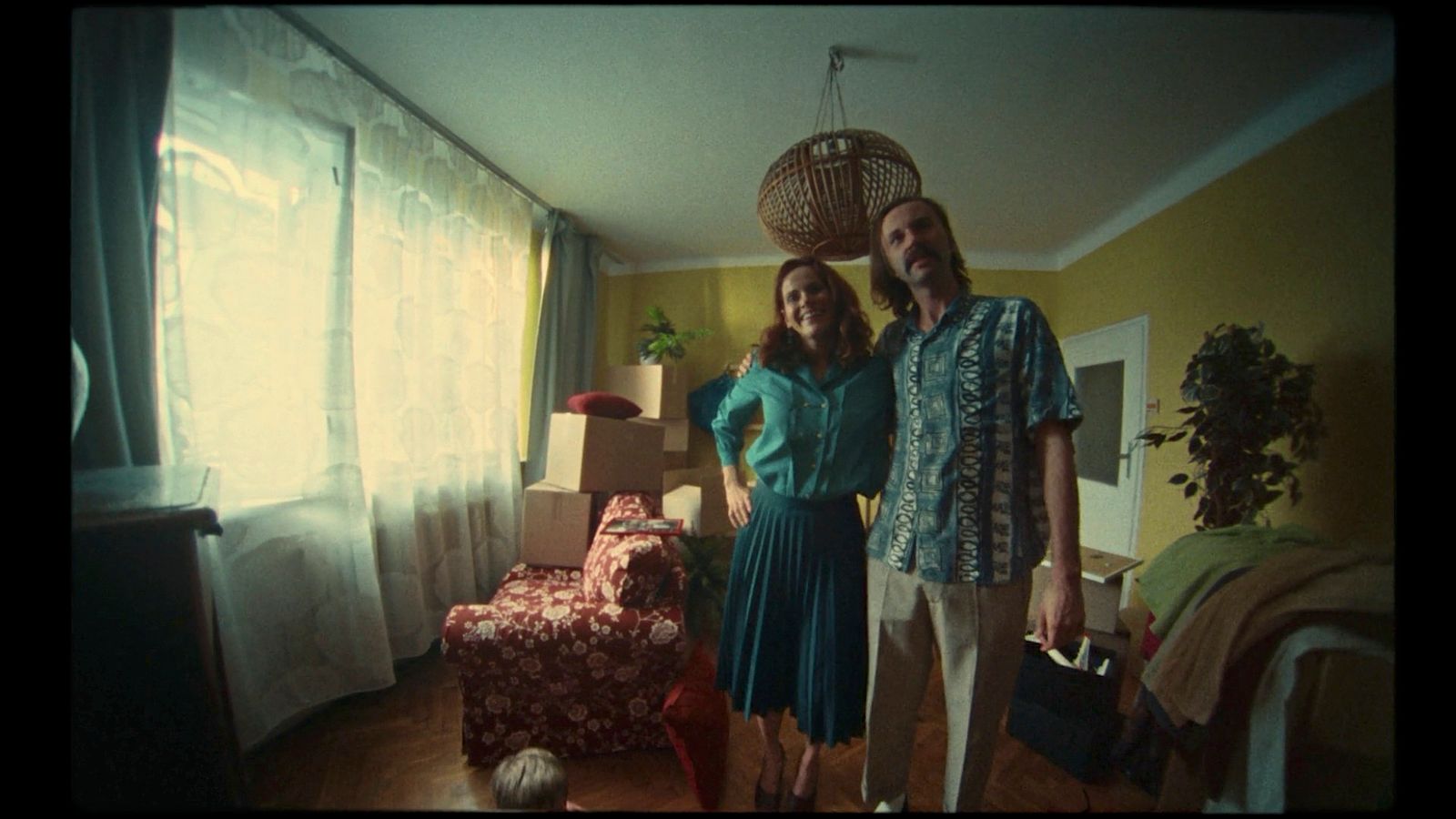 a man and a woman standing in a living room