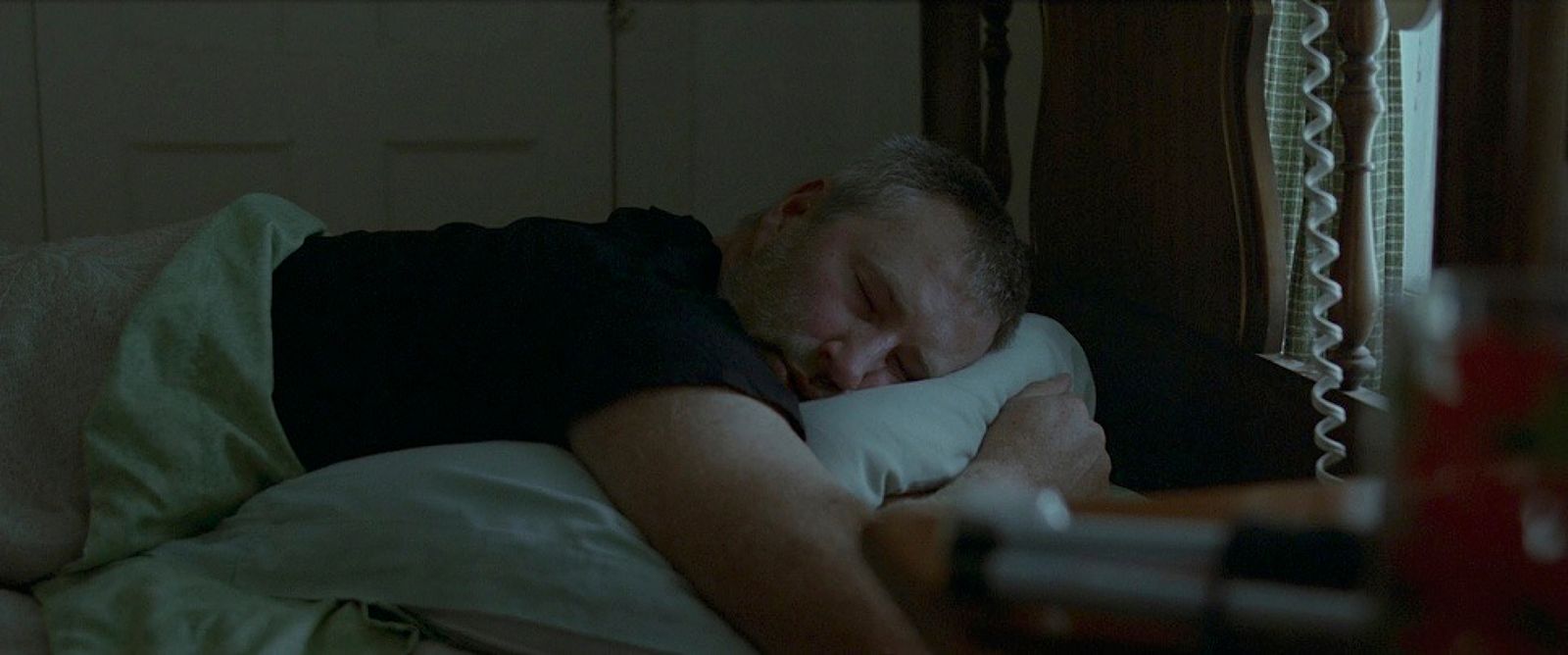 a man sleeping on a bed with a pillow