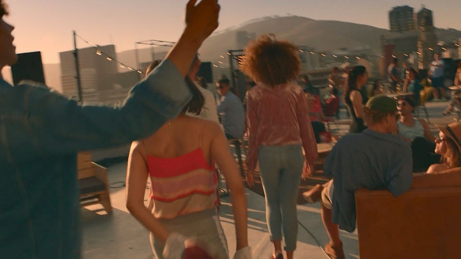 a group of people standing on top of a roof