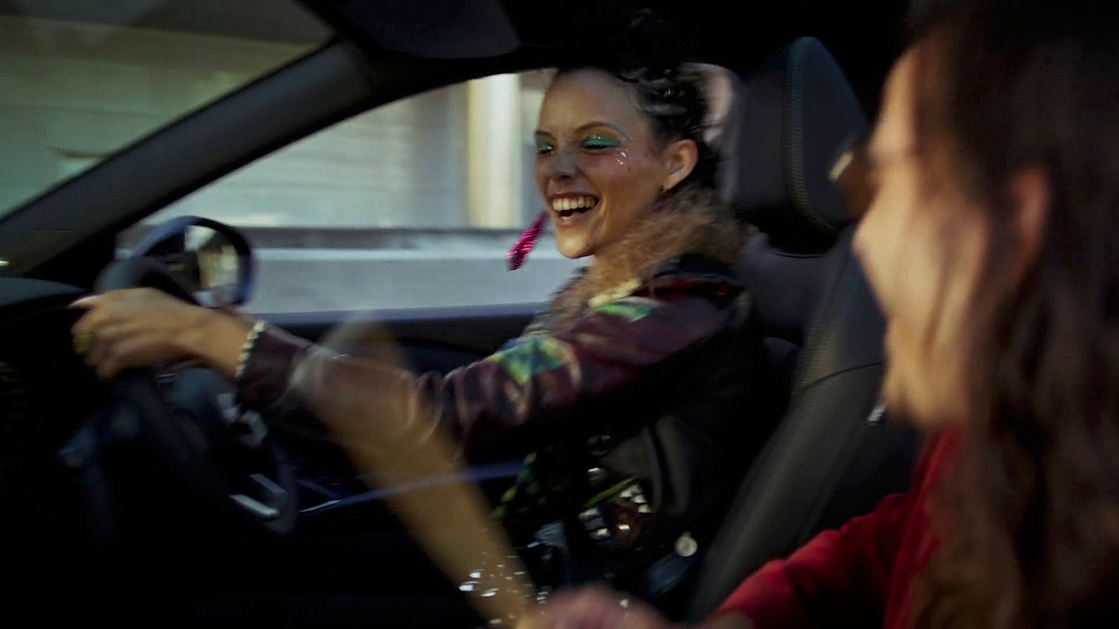 a woman driving a car with a creepy look on her face