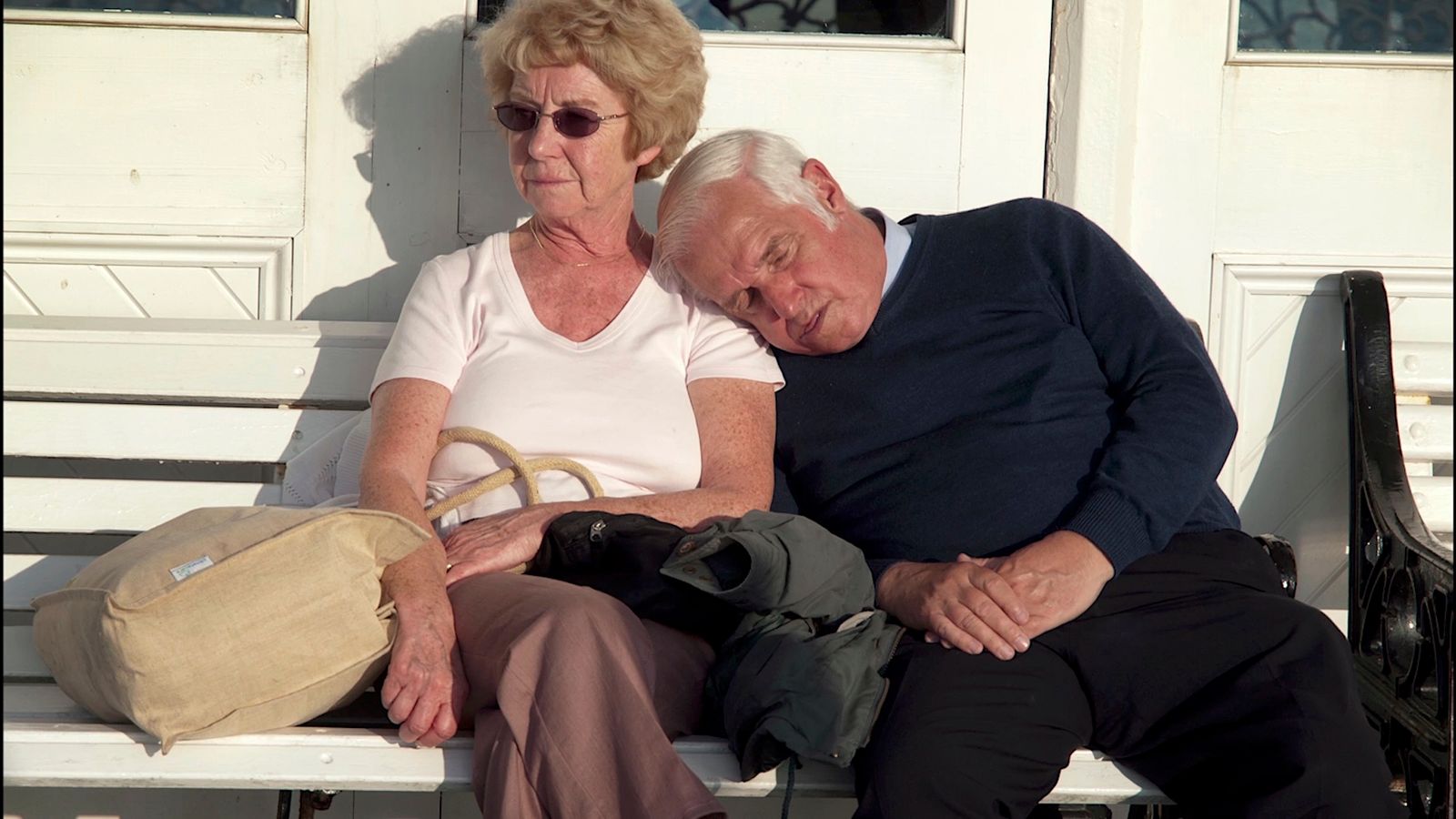 a man and a woman sitting on a bench