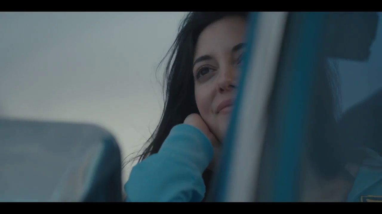 a woman looking out the window of a car