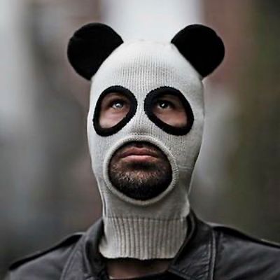 a man wearing a panda mask with a black nose