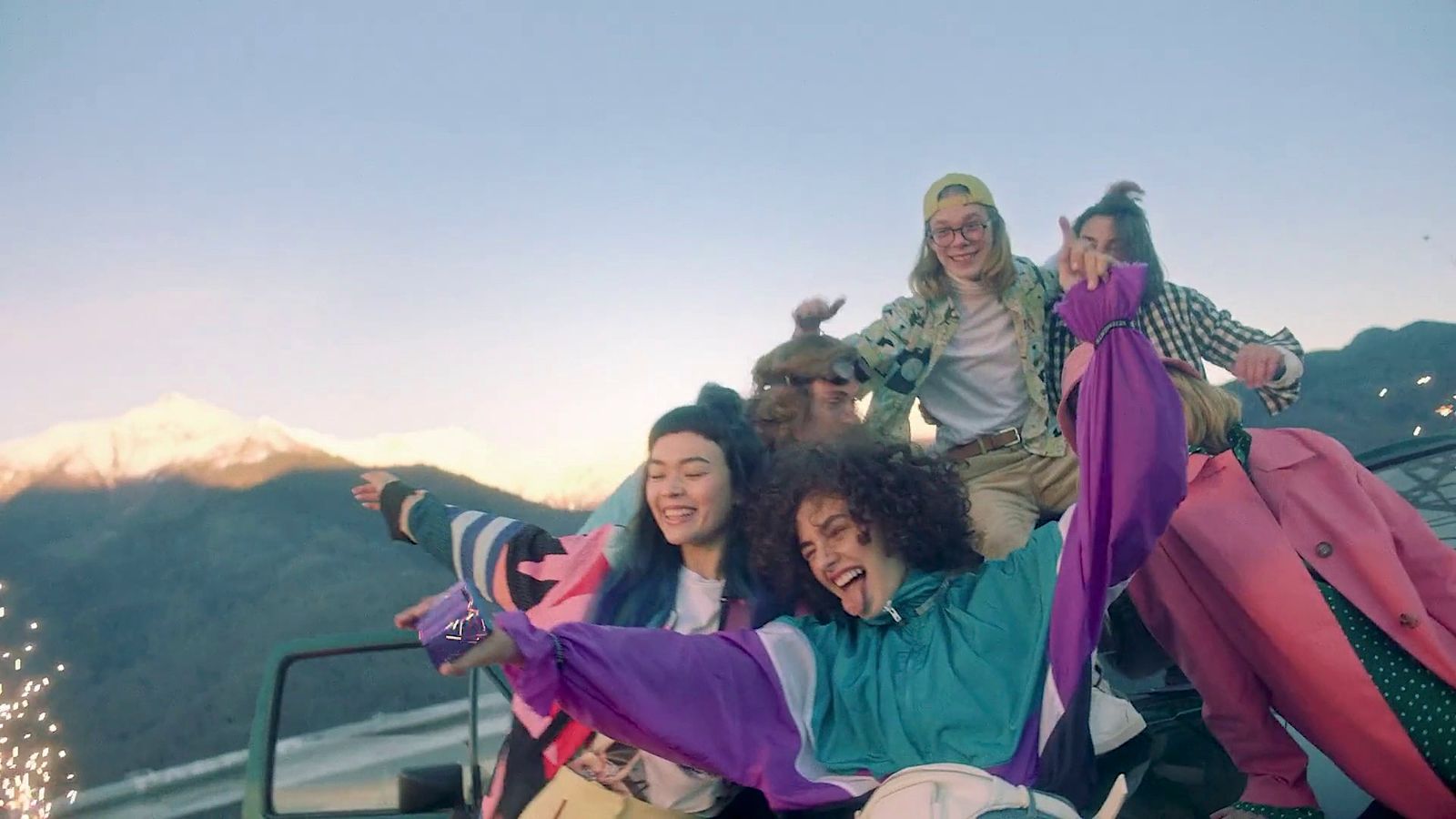 a group of people riding on the back of a truck