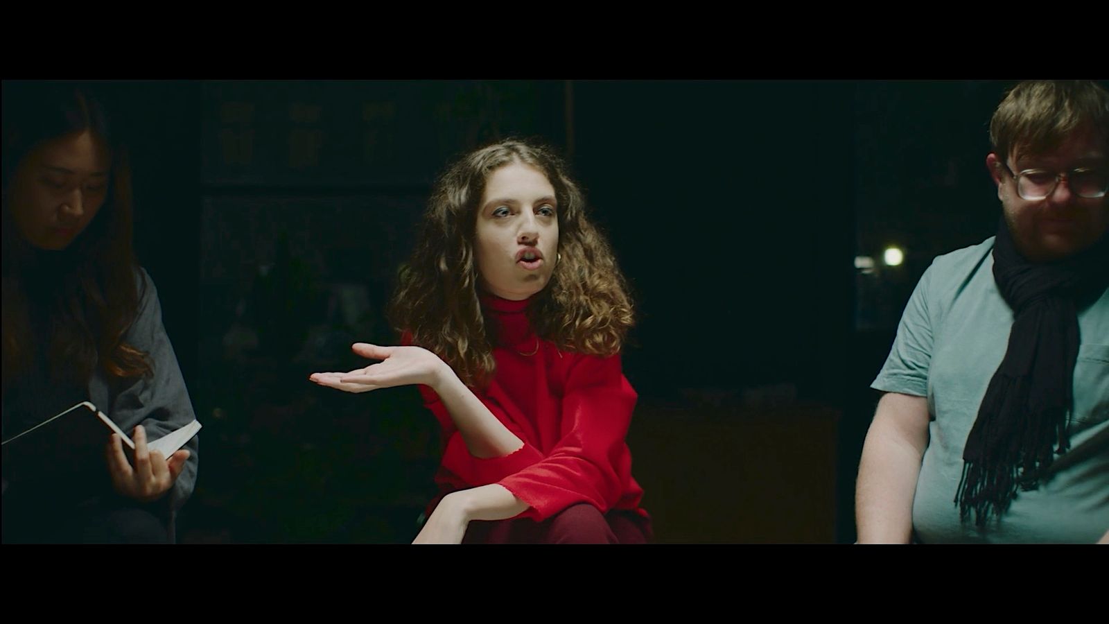 a woman in a red shirt and a man in a green shirt