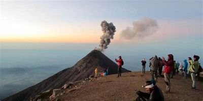 a group of people standing on top of a mountain