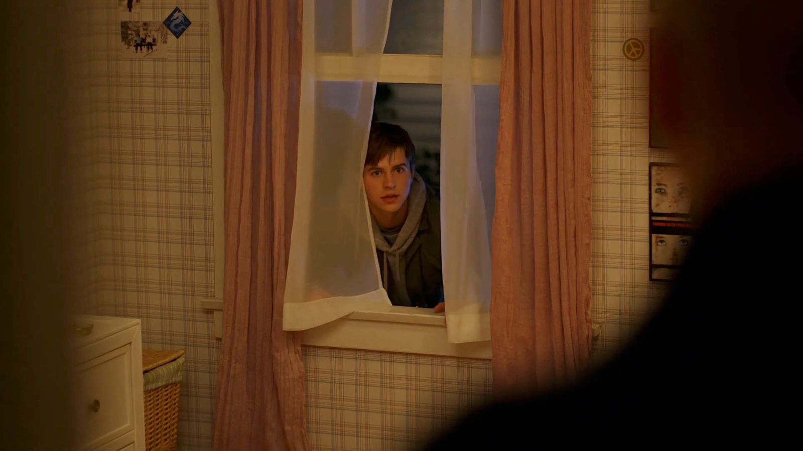 a man looking out of a window in a bathroom