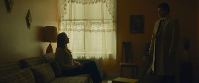 a man and a woman sitting on a couch in a living room