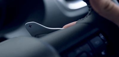 a close up of a person's hand on a steering wheel