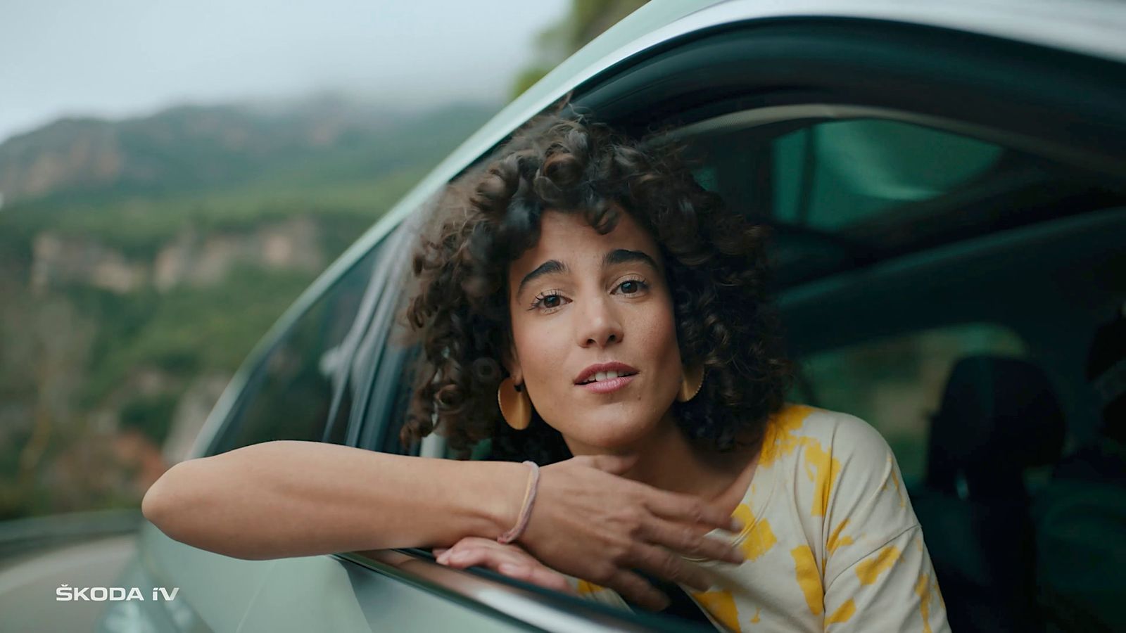 a woman leaning out of a car window