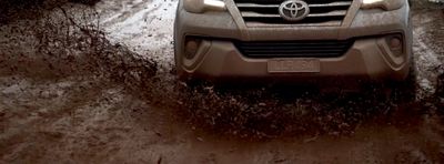 a car is driving through a muddy road