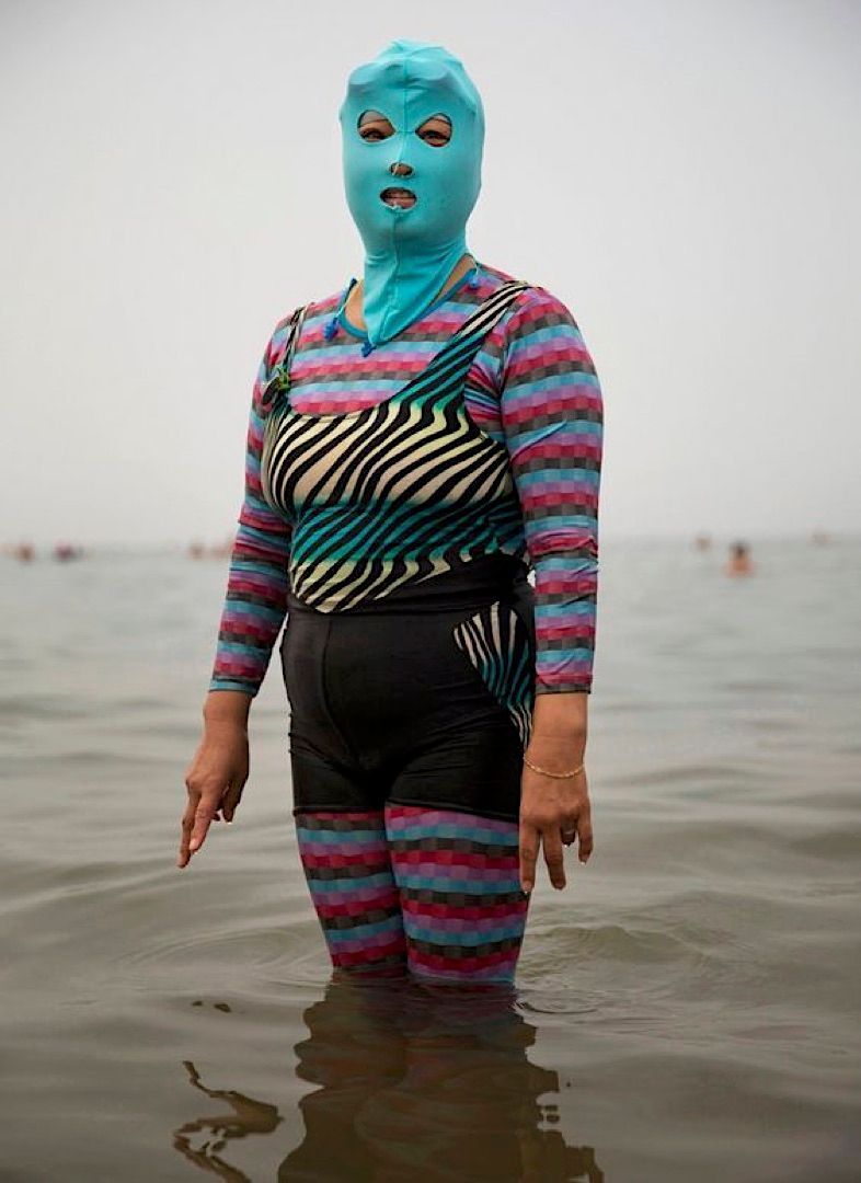 a person in a body of water wearing a blue mask