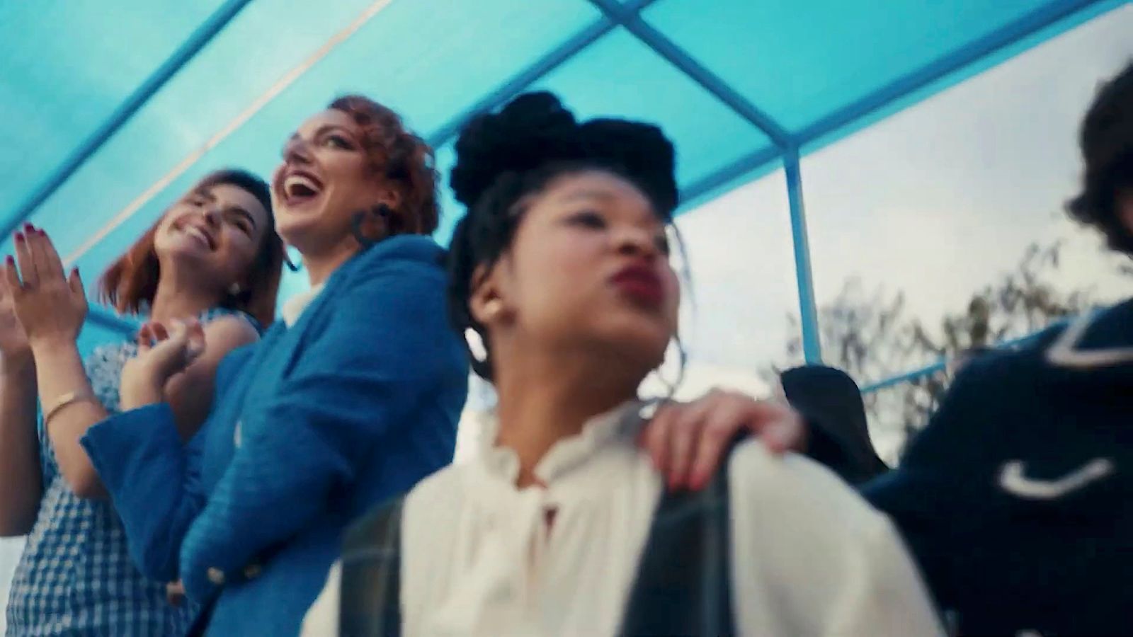 a group of women standing next to each other under a tent