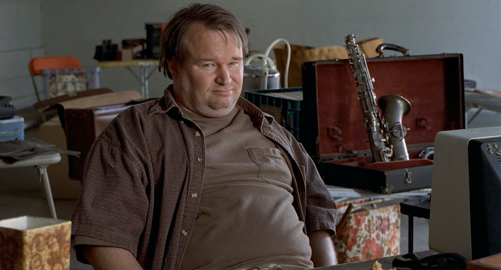 a man sitting in front of a desk with a keyboard