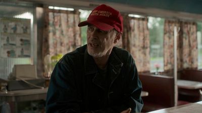 a man wearing a red hat sitting at a table