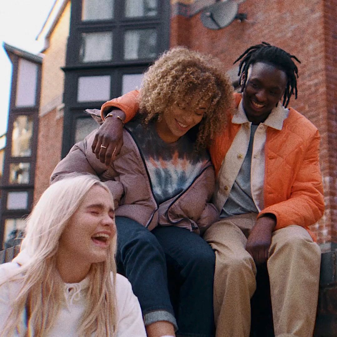 a group of people sitting on top of a brick building