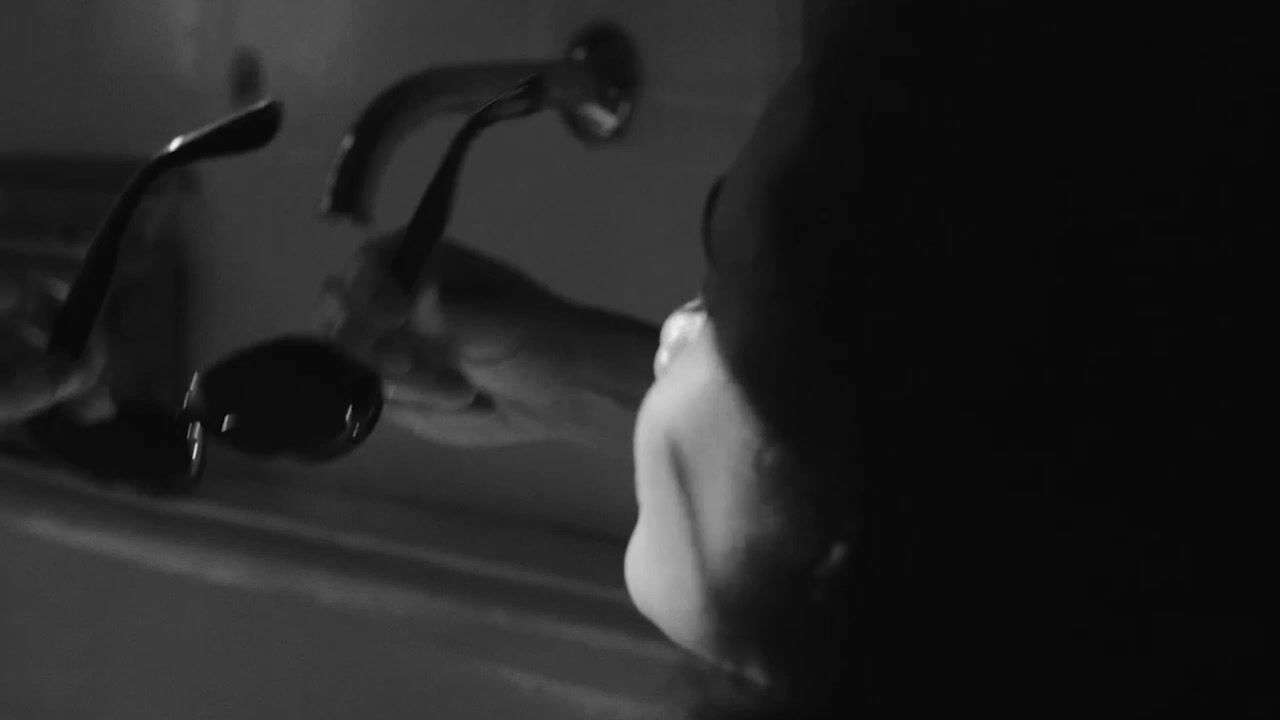 a woman washing her hands in a sink