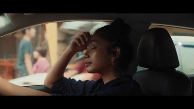 a woman sitting in the passenger seat of a car