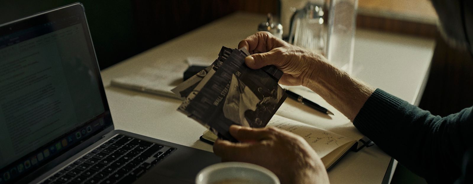 a person sitting at a table with a laptop