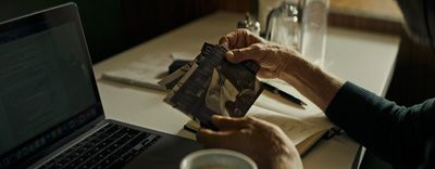 a person sitting at a table with a laptop