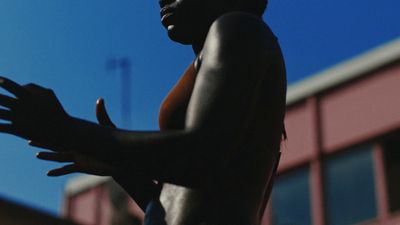 a man with no shirt holding a frisbee