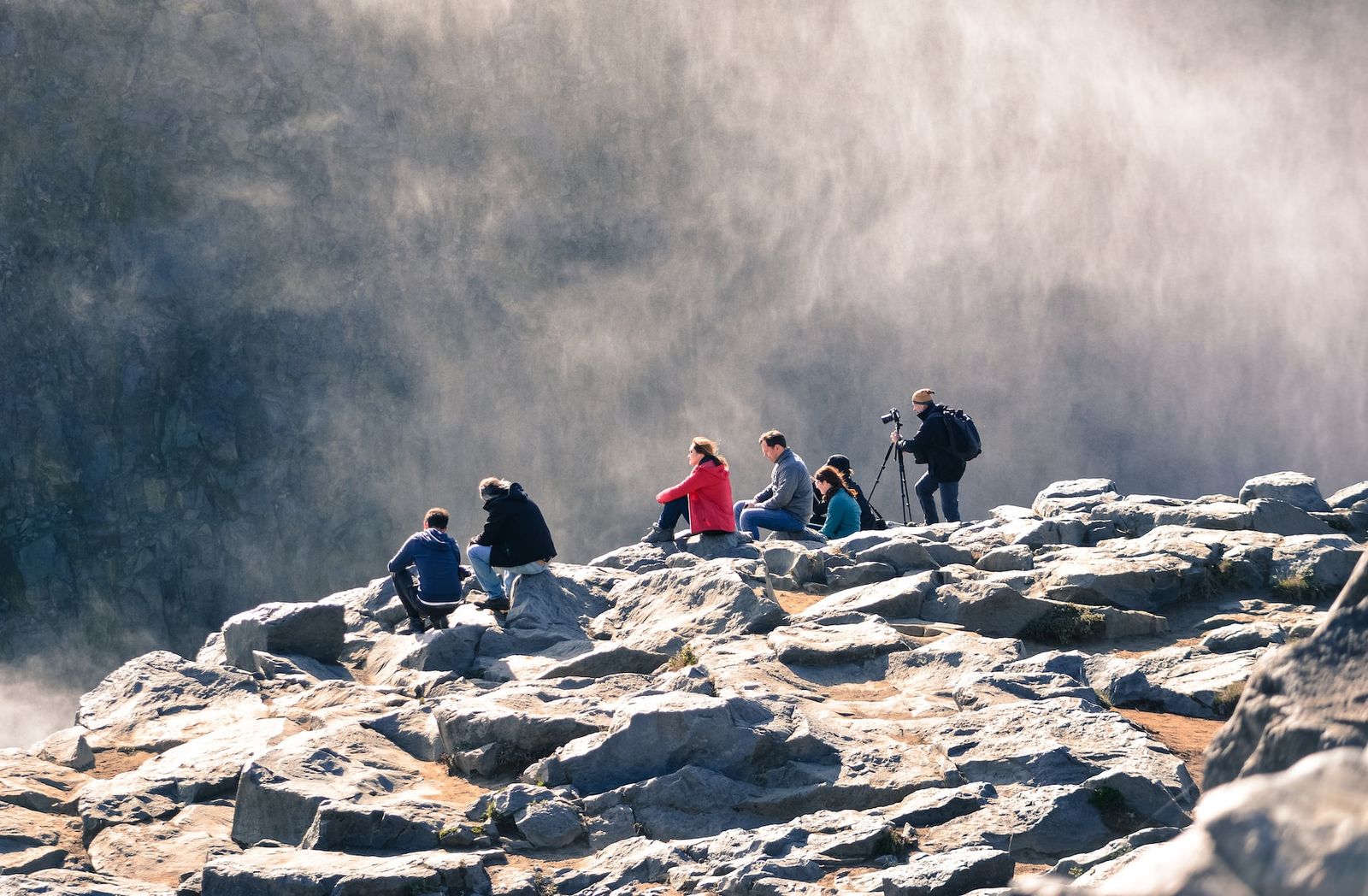 a group of people standing on top of a mountain