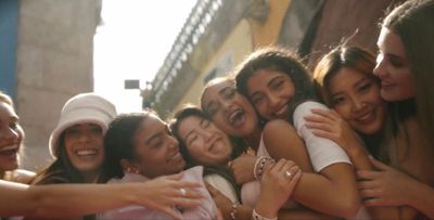 a group of young women standing next to each other