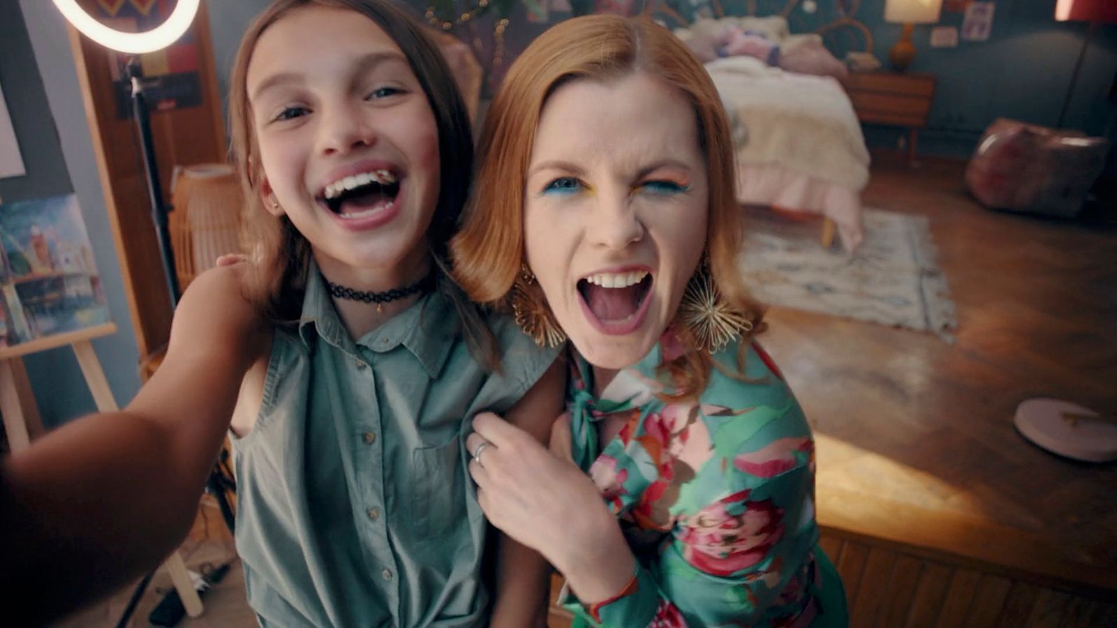 two young girls standing next to each other in a room