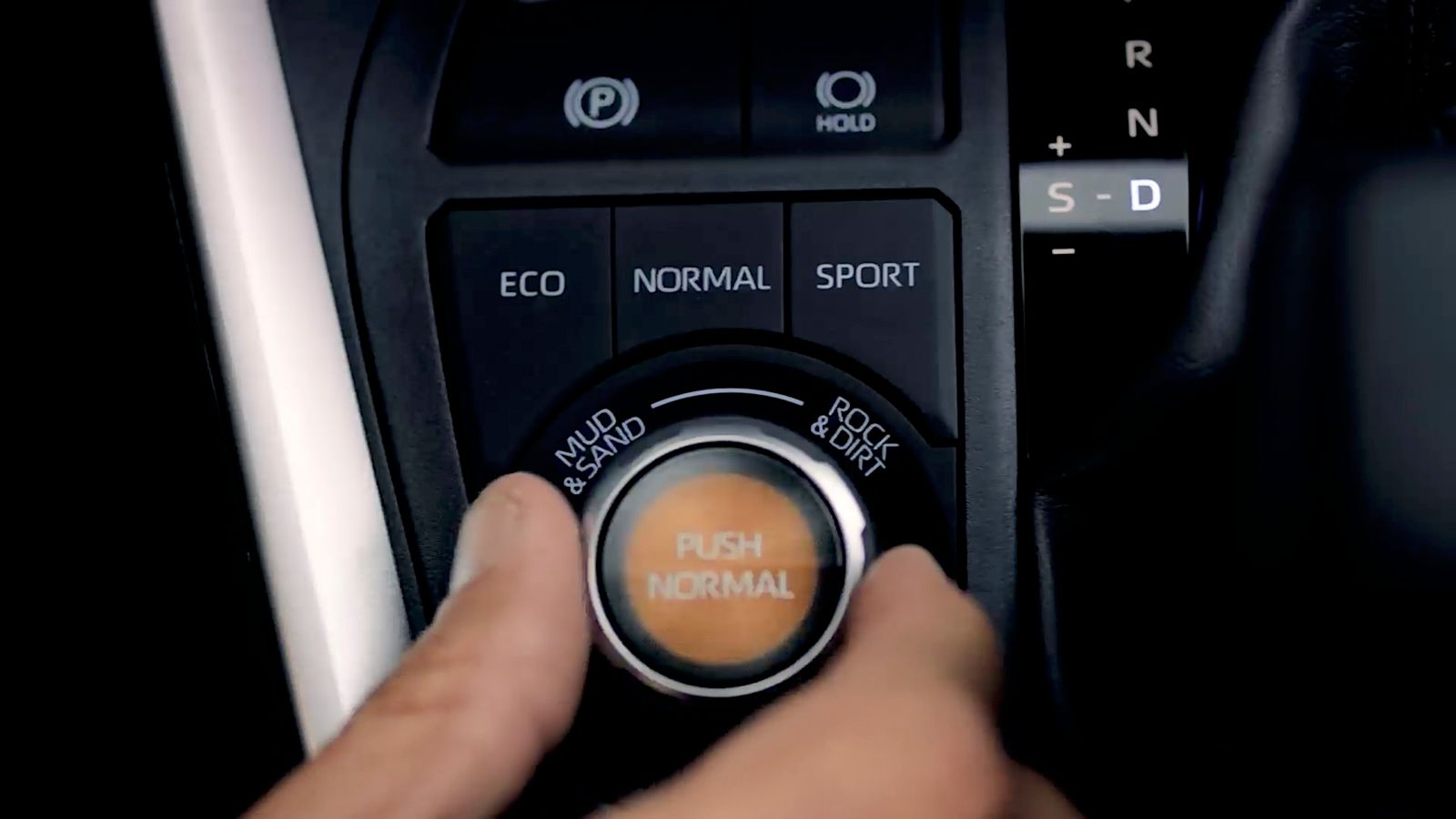 a person turning a button on a car