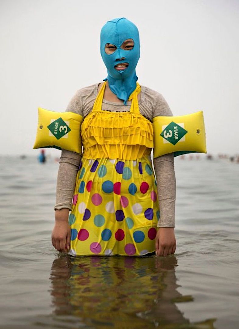 a person wearing a blue mask and yellow apron in the water