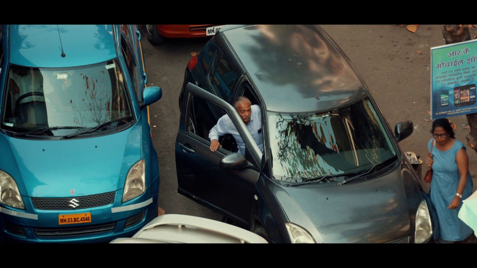 a man in a blue shirt is in a blue van