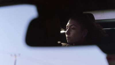 a woman sitting in the passenger seat of a car