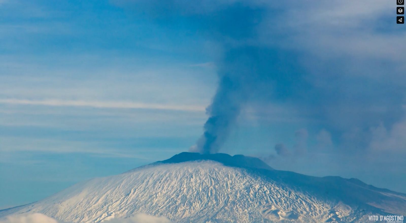 a plume of smoke rising from the top of a mountain