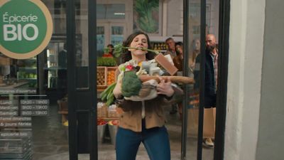 a woman holding a bunch of vegetables in her hands