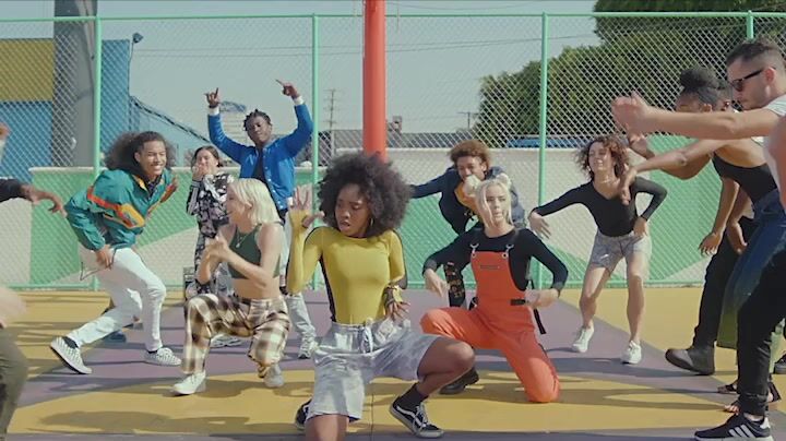 a group of young people dancing on a basketball court