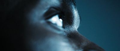 a close up of a person's face with a blue background