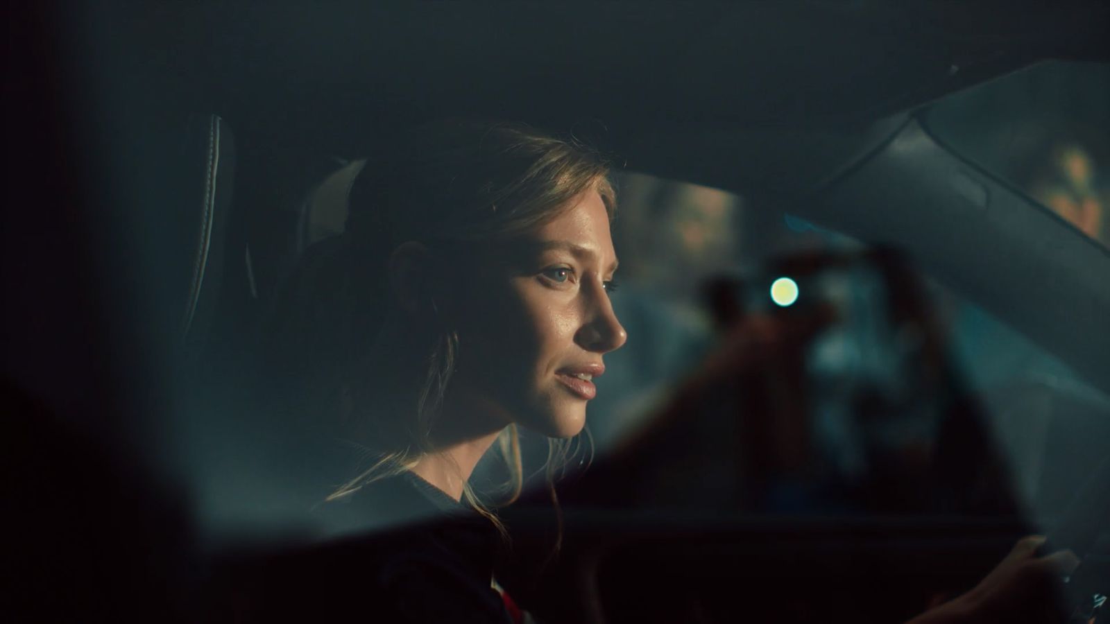 a woman sitting in the passenger seat of a car