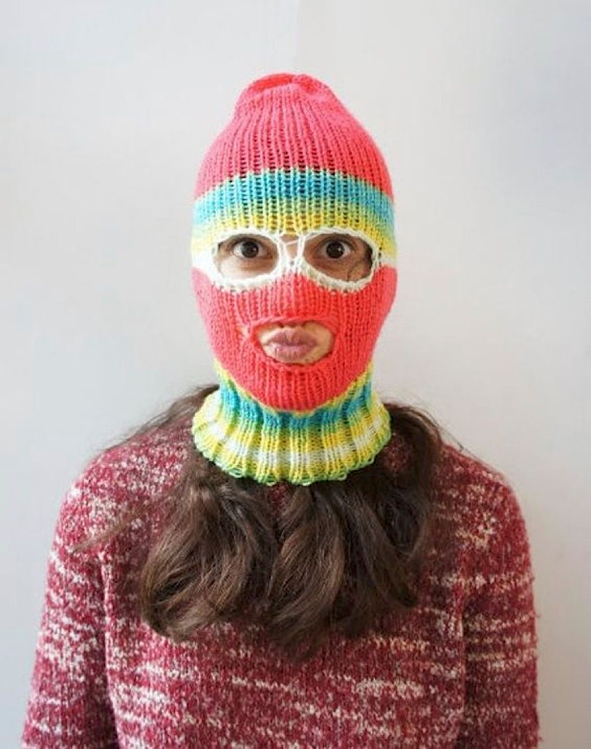 a woman wearing a knitted hat and scarf