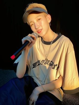 a young man sitting on a couch holding a microphone