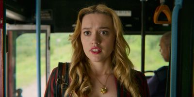 a woman sticking out her tongue on a bus