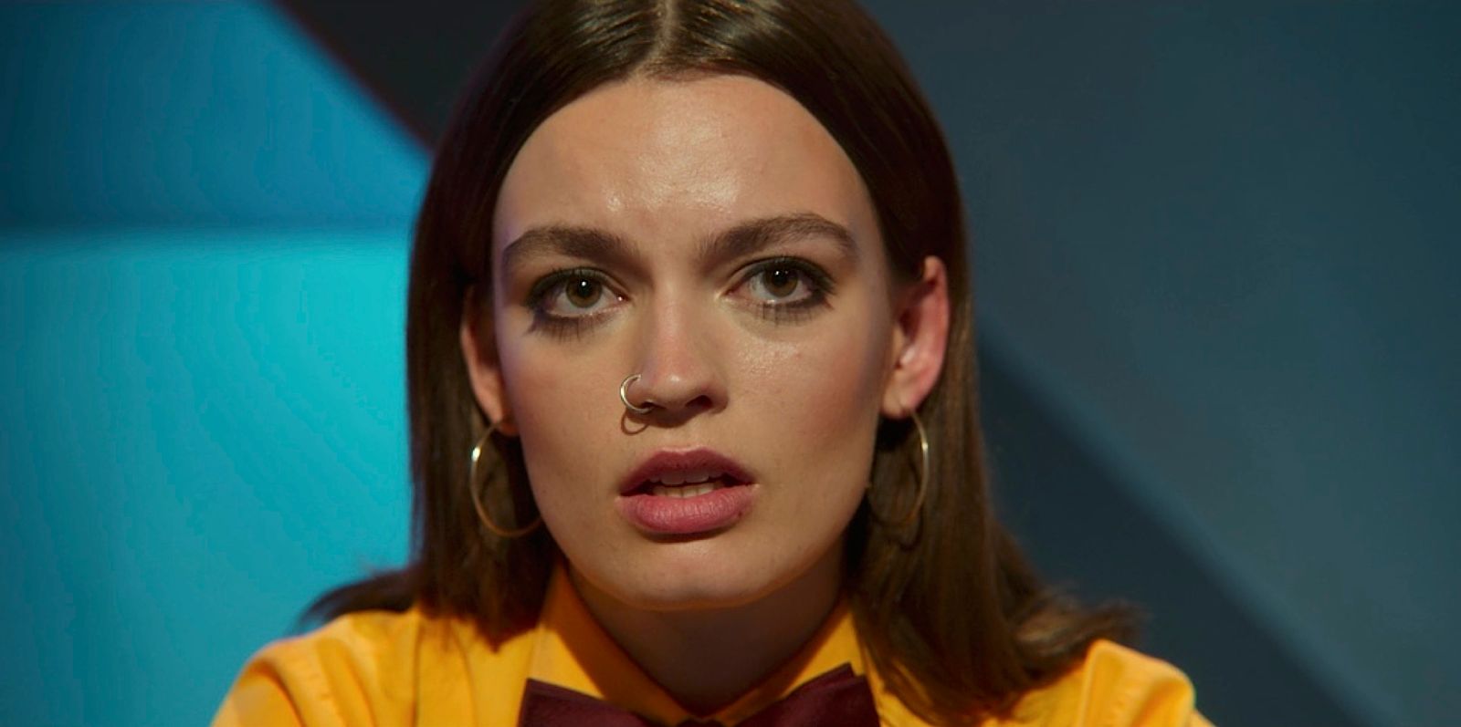 a woman wearing a yellow shirt and a bow tie