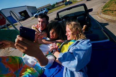 a group of people sitting in the back of a car