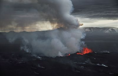 a large plume of smoke rising from a volcano