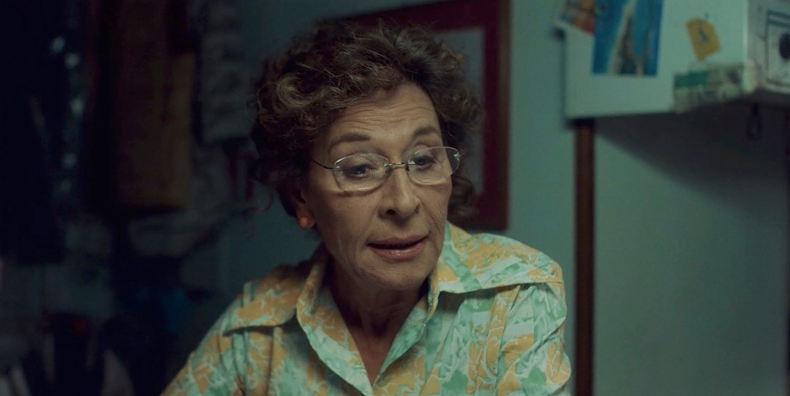 an older woman with glasses is staring at the camera