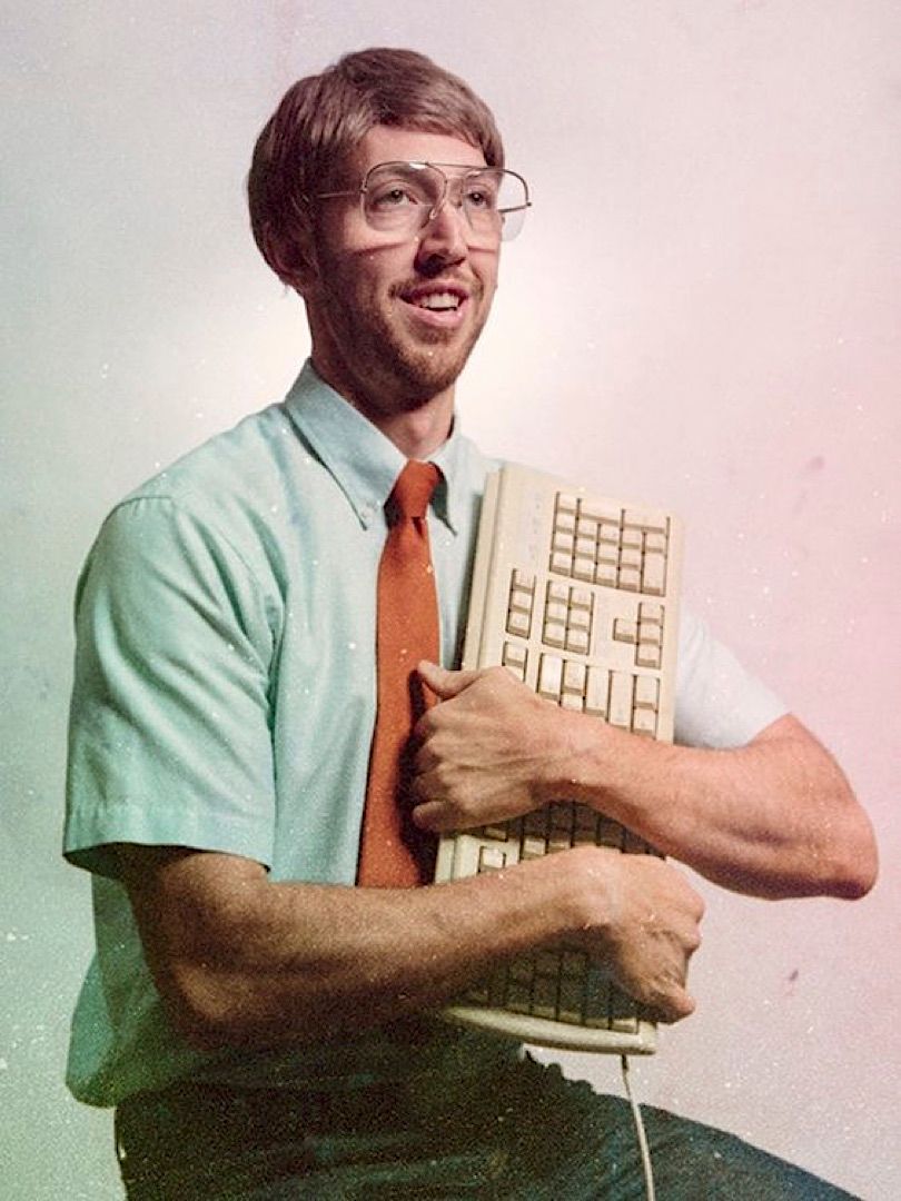 a man holding a computer keyboard in his hands