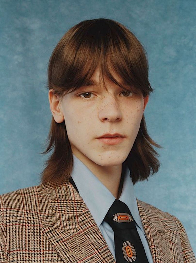 a man in a suit and tie posing for a picture