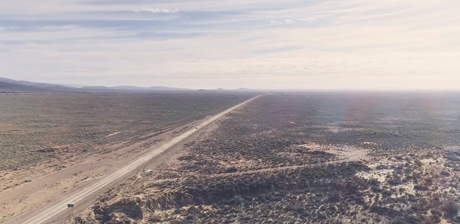 an aerial view of a road in the middle of the desert