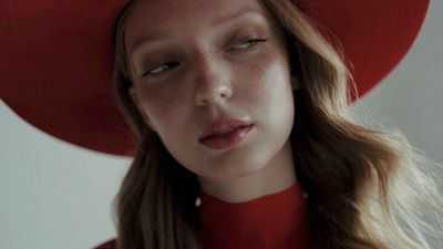 a woman wearing a red hat and a red dress