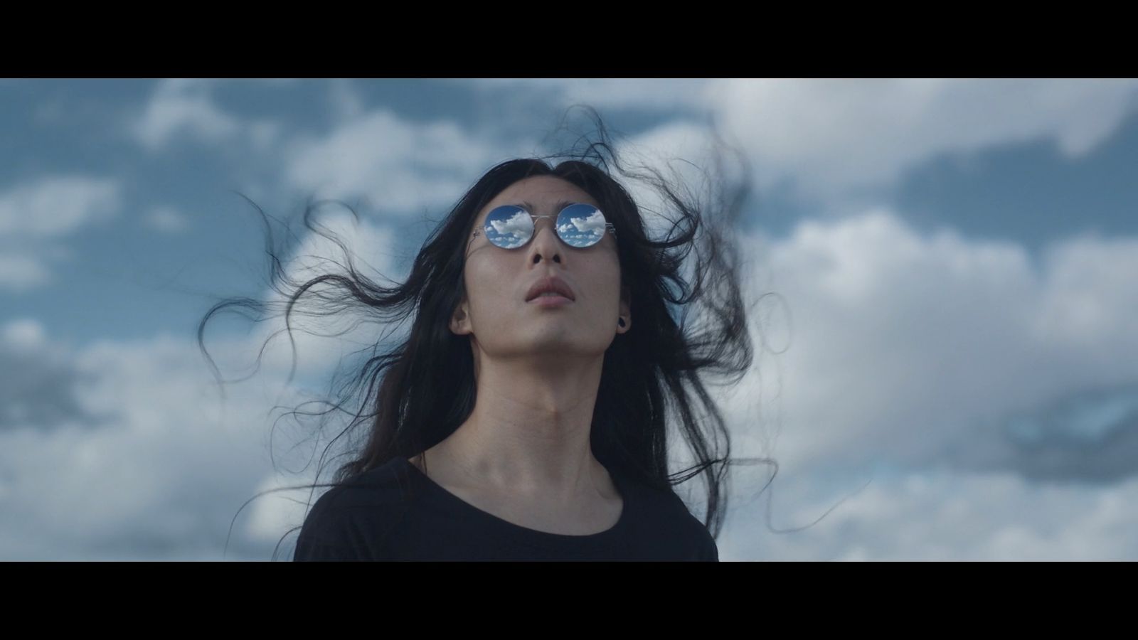 a woman with her hair blowing in the wind